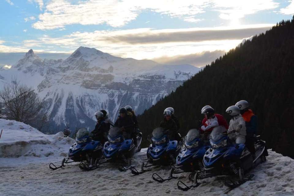 Snowmobiling in the Grand Massif ski area with view of the Aravis mountains